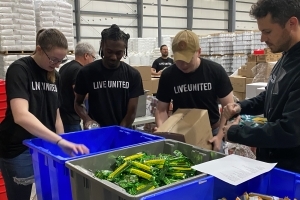 Volunteers pack food for students