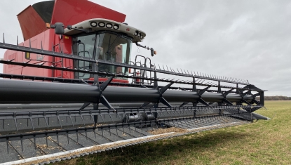 A combine is parked in a McComb field