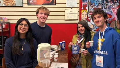 Student volunteers serve samples to participants of United Way of Hancock County's Downtown Restaurant Tour.