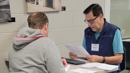 A VITA volunteer helps a client