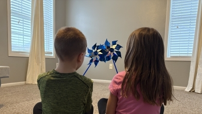 Youth hold pinwheels for child abuse awareness