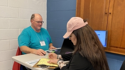 A VITA volunteer assists a client with her taxes