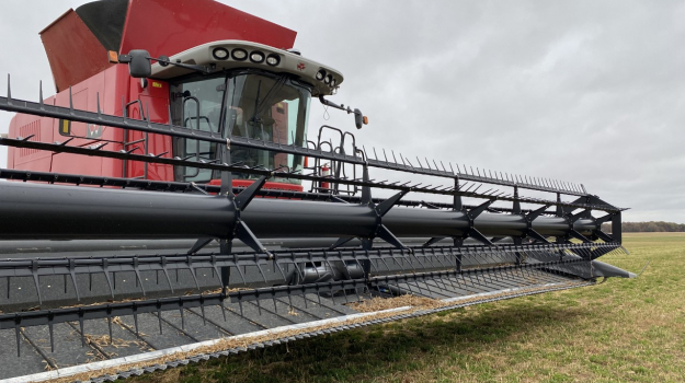 A combine is parked in a McComb field